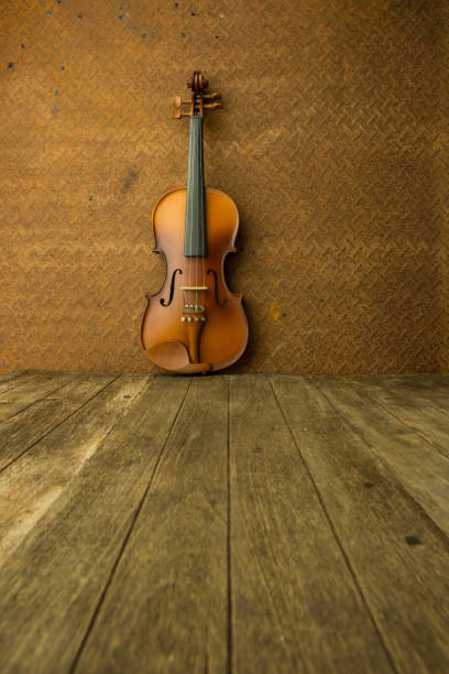 Vintage violin with old steel background with copy space