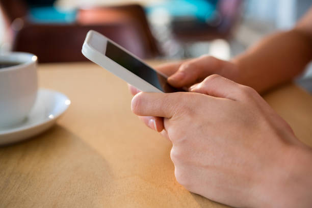 istock Close-up of hands using a mobile phone 652177164