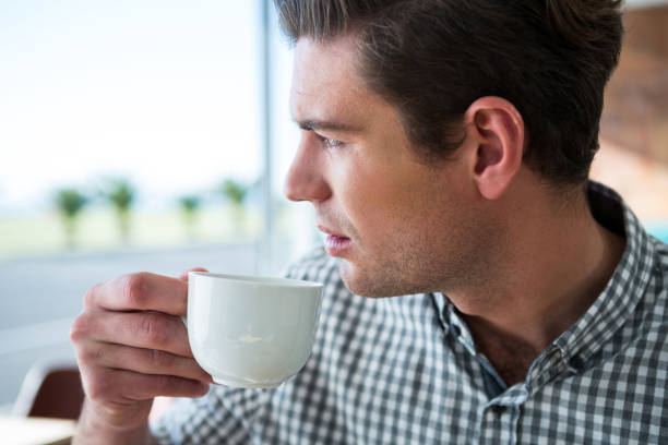 istock Thoughtful man looking out of the window while having coffee 652177268
