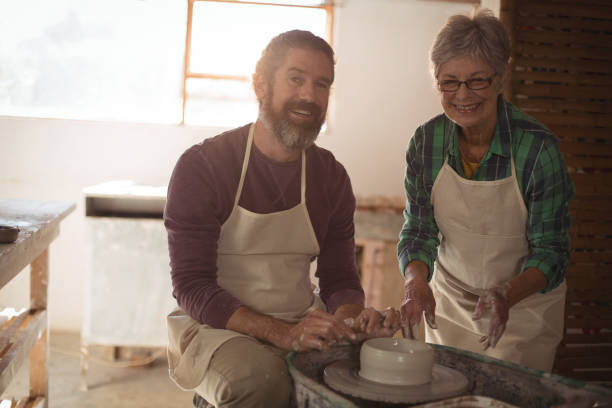 istock Male and female potter making a pot 652180260