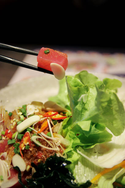 istock Salmon sashimi with sticks with vegetable and spicy mix 652184510