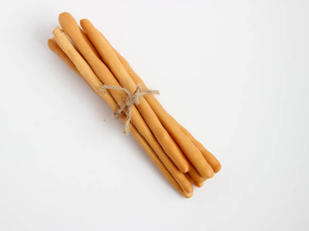 istock Homemade bread sticks on white background,with rope bundle. 652184722