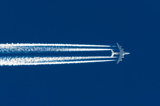 Airplane big four engines aviation airport contrail clouds Airplane big four engines aviation airport contrail clouds. vapor trail photos stock pictures, royalty-free photos & images