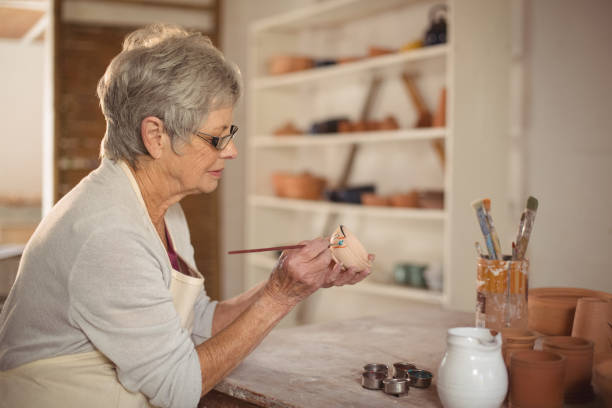 istock Female potter painting on bowl 652188314