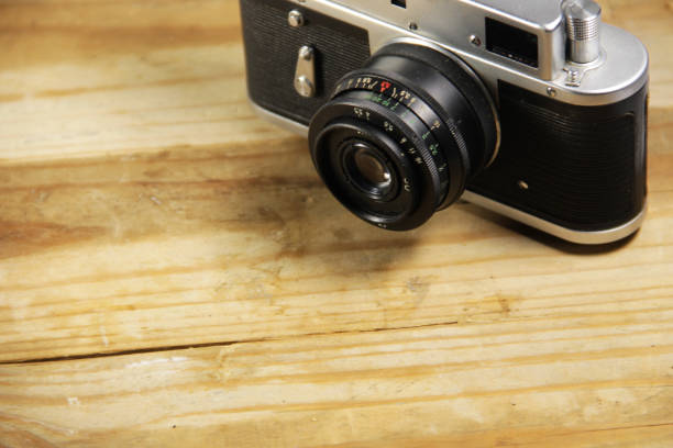 istock Retro photo camera on wooden background 652194948