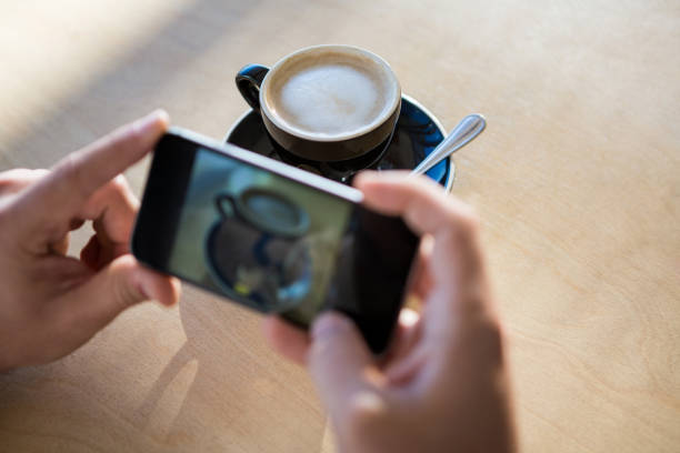 istock Female hands photographing a coffee cup 652195108