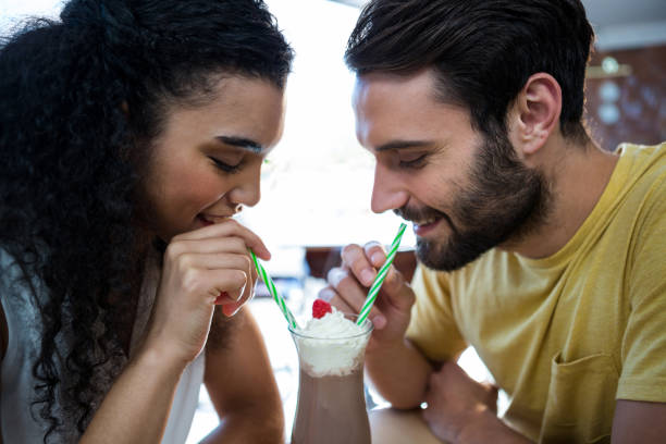 istock Couple having milkshake in coffee shop 652195494