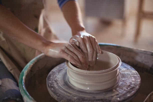 istock Close-up of female potter making pot 652199376