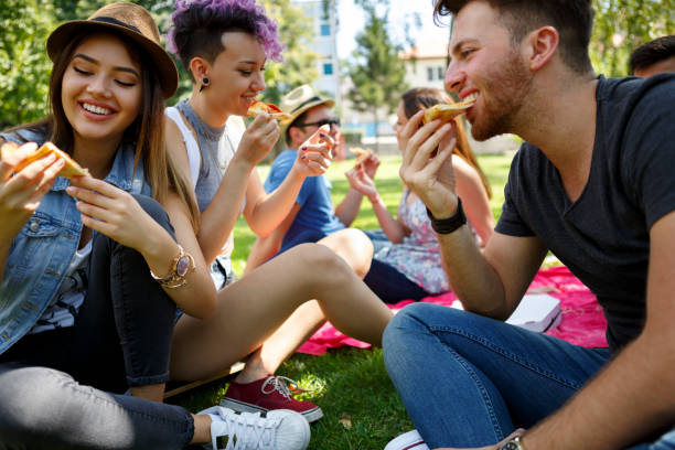 istock Friends eating pizza outside 652199618