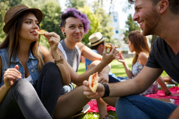 istock Friends eating pizza outside 652199710