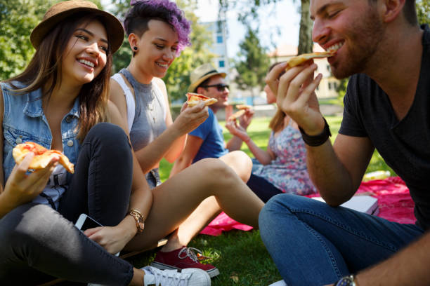 istock Friends eating pizza outside 652199720