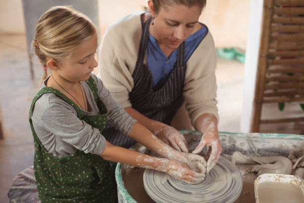 istock Female potter assisting girl 652199764