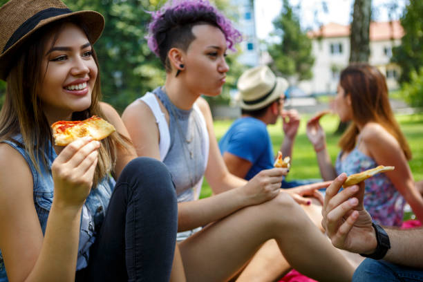 istock Friends eating pizza outside 652199856