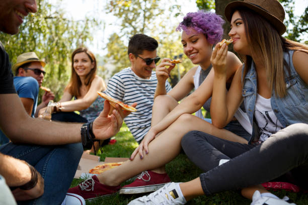 istock Friends eating pizza outside 652199890