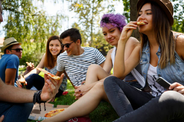 istock Friends eating pizza outside 652200024