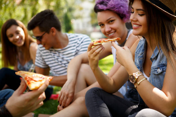 istock Friends eating pizza outside 652200026