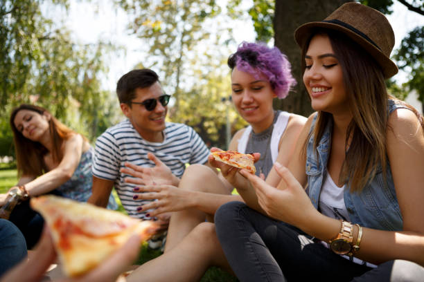 istock Friends eating pizza outside 652200088