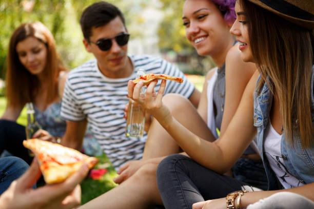istock Friends eating pizza outside 652200128