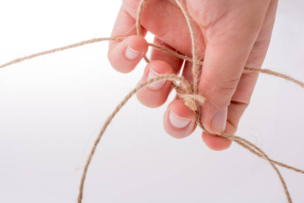 istock Hand holding brown color linen thread in hand 652202384