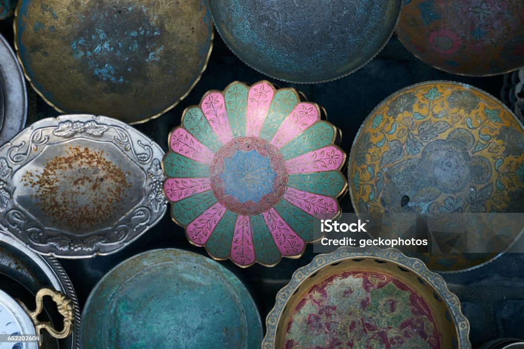 Collection of old rarity metal, ceramic and silver plates Collection of old rarity metal, ceramic and silver plates on wooden background. Stock Market and Exchange Stock Photo