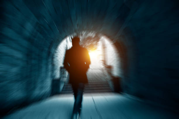 A man walking  in an old tunnel, China.