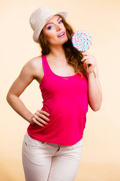 istock Woman holds colorful lollipop candy in hand 652202968
