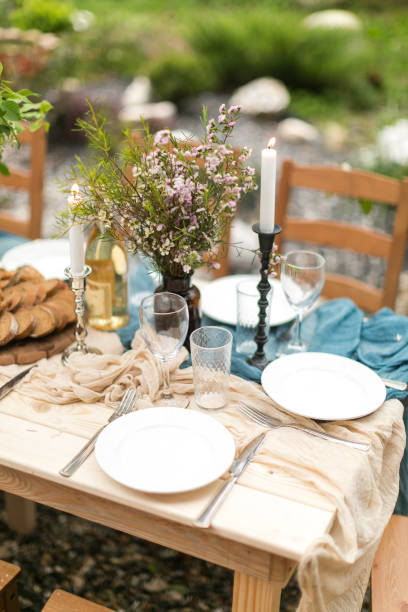 istock spring festive lunch an outdoors, wedding decor of a table, table layout, the fresh cut bread, bouquet of wild flowers in a vase 652203498