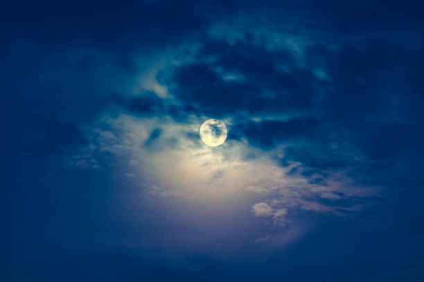 istock Nighttime sky with clouds and bright full moon with shiny. 652203828