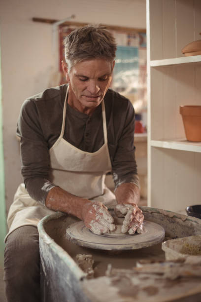 istock Male potter making pot in pottery workshop 652210658