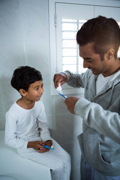 istock Father and son brushing teeth in the bathroom 652214748