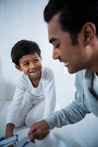 istock Father and son brushing teeth in the bathroom 652214778
