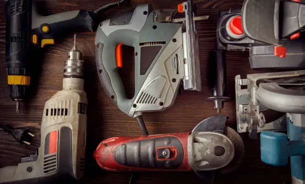 Photo of grungy old tools on a wooden background