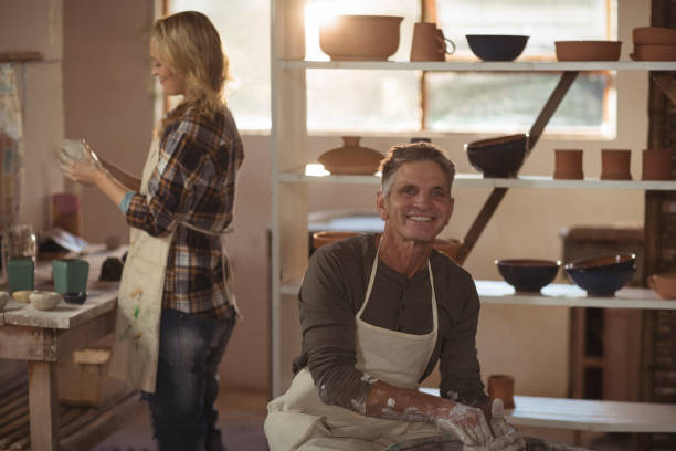 istock Smiling male potter making pot in pottery workshop 652222010