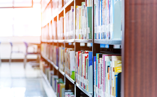 University library with large group of books on the shelf.