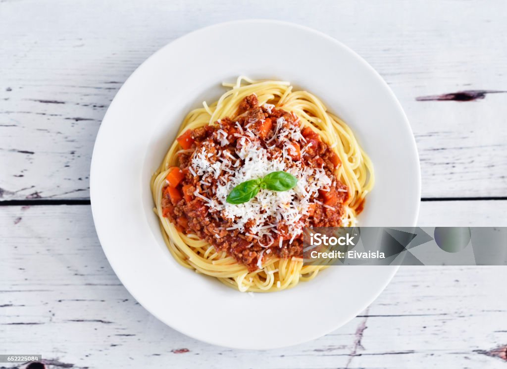 Spaghetti Bolognese on a white plate Spaghetti Bolognese on a white plate with decorative basil leaf. Italian cuisine, pasta with tomato sauce and parmesan cheese. Pasta Stock Photo