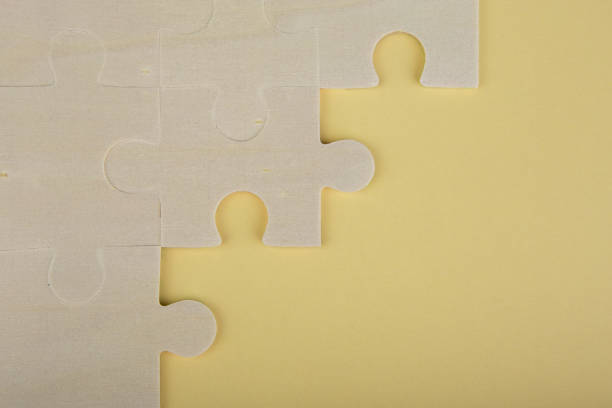 istock Wooden puzzle pieces on a yellow background 652225086
