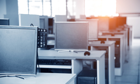 Row of computers at an university computer classroom.