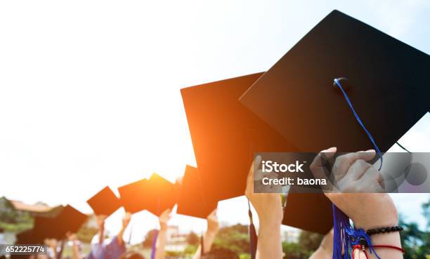 Holding Graduation Hats Stock Photo - Download Image Now - Graduation, Campus, University