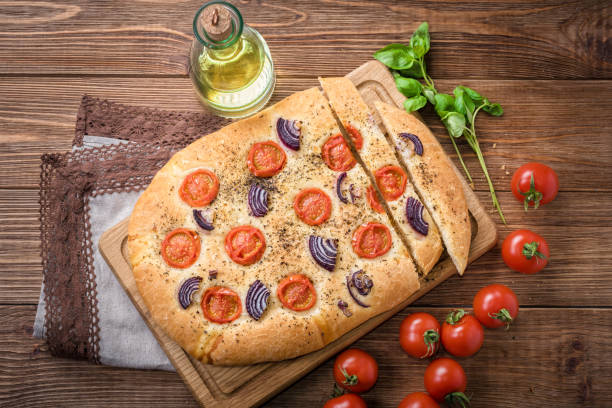 Focaccia with caramelized onion and tomato . Bread.