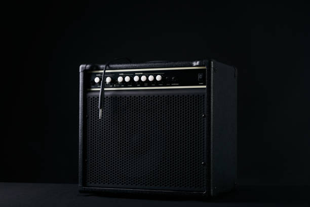 istock Black guitar amplifier with jack cable on black background. 652229222