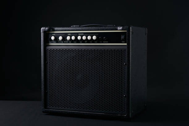 istock Electric bass Guitar black leather Amplifier on black Background. 652229302