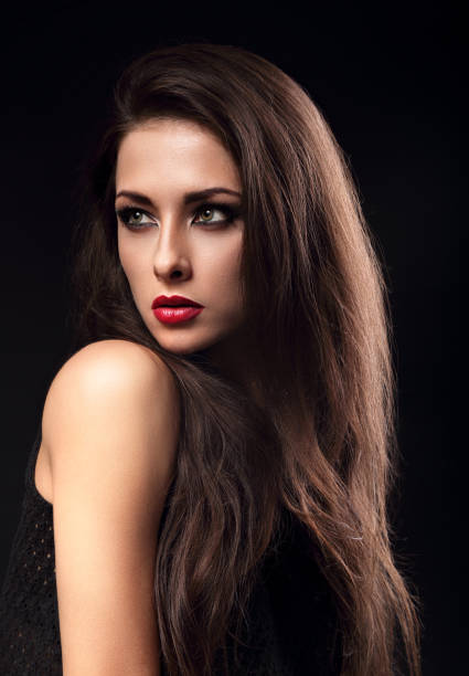istock Beautiful makeup expressive female model profile with red lipstick and long eyelashes looking sexy on dark background. Closeup portrait 652232940