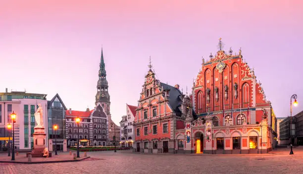 City Hall Square with House of the Blackheads and Saint Peter church in Riga Old Town During sunset time.