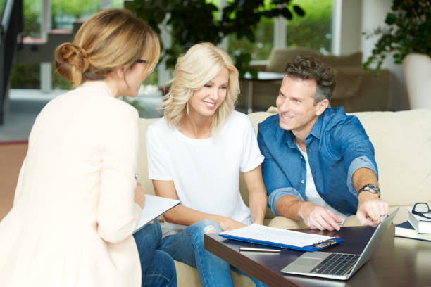 istock Happy couple with investment advisor 652237730