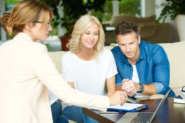 istock Happy couple with investment advisor 652237734