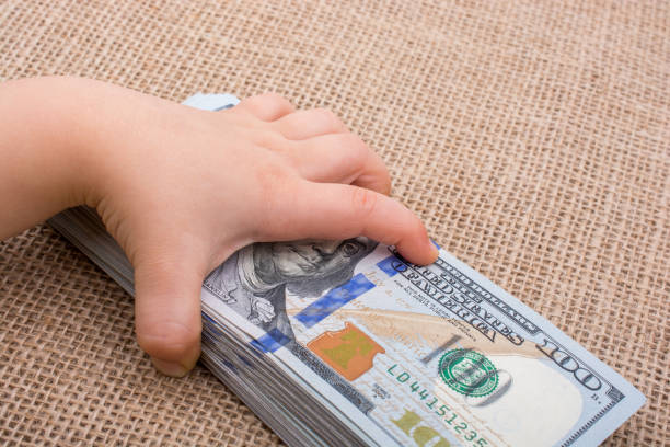 istock Toddler hand holding banknote bundle of US dollar in hand 652241322