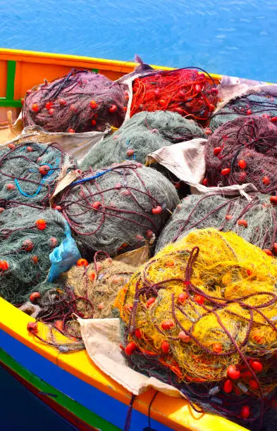 Piles of colorful fishing nets on the dock at Marsaxlokk