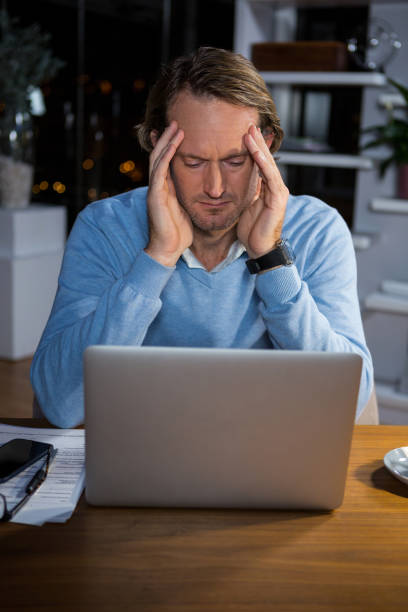 istock Frustrated businessman sitting in office 652256000