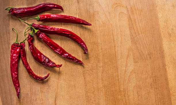 istock Spicy background with hot chilies over rusty wooden background. 652256024
