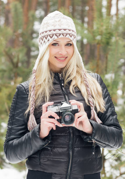 istock Young attractive blonde woman with an old camera 652259512